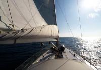 sailing yacht sailing to horizon sun sailboat yacht boom mainsail
